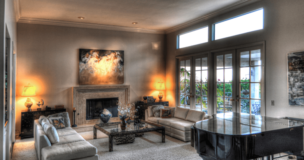 There is no evidence of insulating interior walls here. The image shows a living room decorated with nice furniture, art hangs on the wall, and sunlight beams through the window.